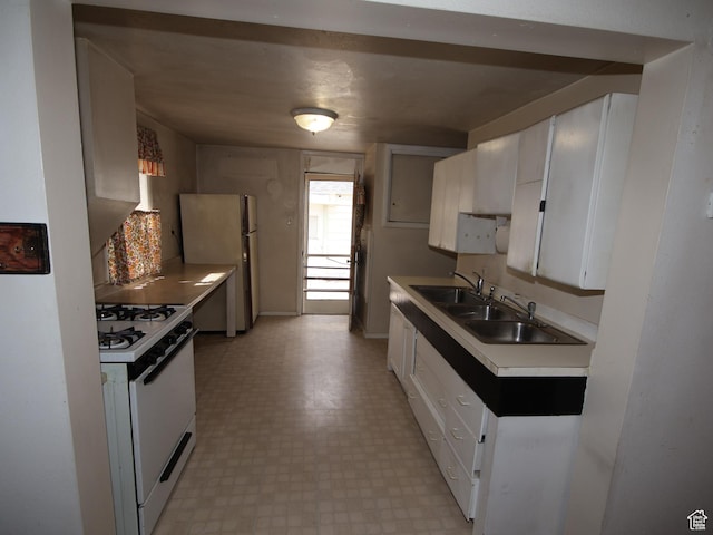 338 E 200 S Unit 338, Logan, UT 84321 - kitchen featuring white appliances, a sink, light flooring, white cabinetry, and light countertops