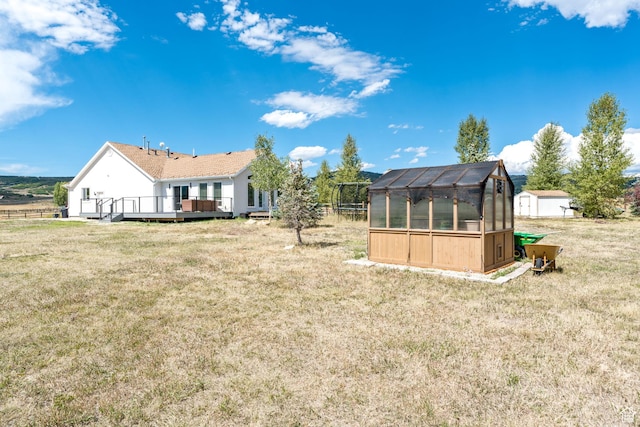 7850 Wasatch Way, Park City, UT 84098 - back of house with an exterior structure, an outdoor structure, a wooden deck, and a lawn