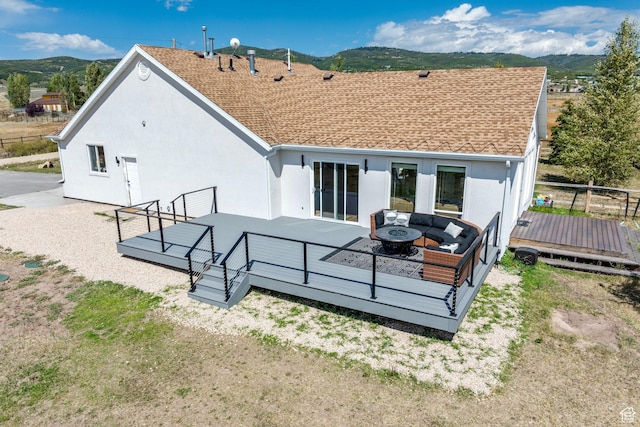 7850 Wasatch Way, Park City, UT 84098 - back of house featuring a deck with mountain view, stucco siding, and an outdoor living space with a fire pit