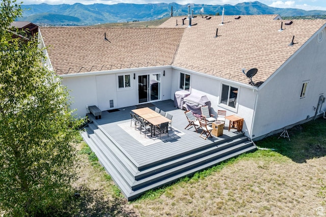 7850 Wasatch Way, Park City, UT 84098 - back of house with stucco siding, a deck with mountain view, roof with shingles, and outdoor dining area