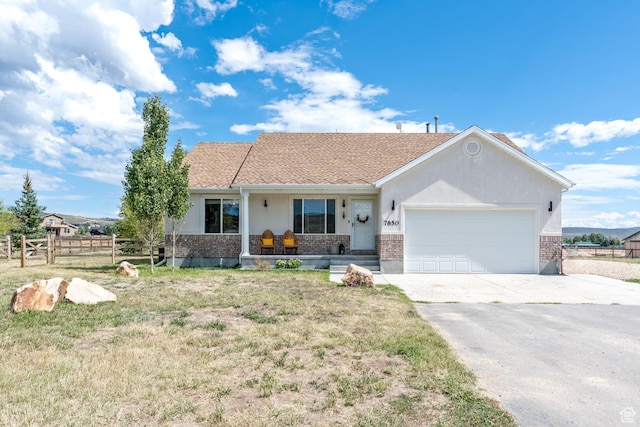 7850 Wasatch Way, Park City, UT 84098 - ranch-style house with covered porch, brick siding, driveway, and an attached garage