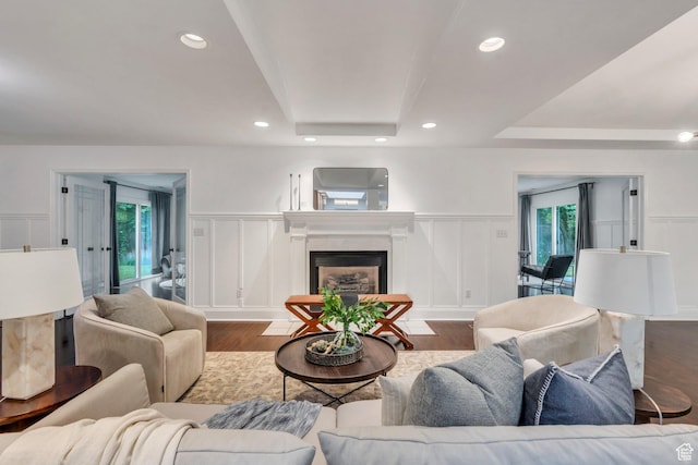 4055 N Cove Dr, Provo, UT 84604 - living area featuring a decorative wall, wood finished floors, a raised ceiling, a fireplace, and wainscoting