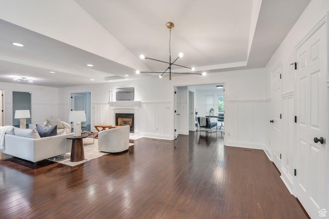 4055 N Cove Dr, Provo, UT 84604 - living area with a decorative wall, dark wood-style flooring, a chandelier, recessed lighting, and a fireplace with raised hearth