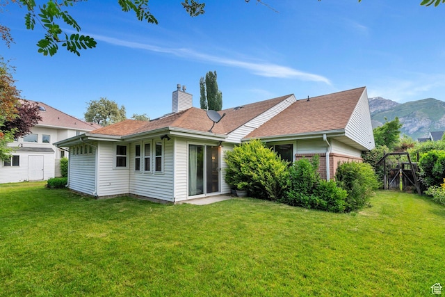 4055 N Cove Dr, Provo, UT 84604 - back of house with a chimney, a lawn, and a mountain view