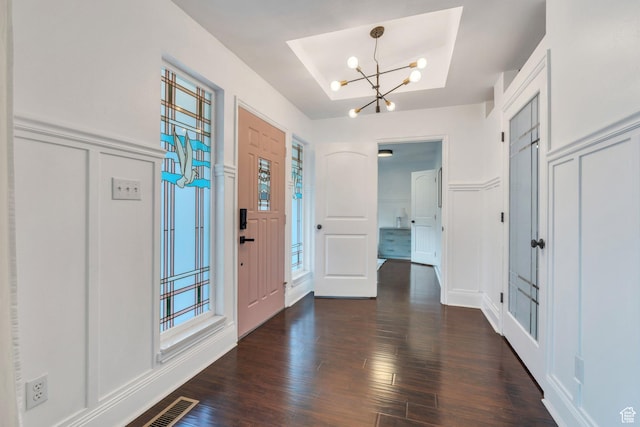 4055 N Cove Dr, Provo, UT 84604 - foyer with a decorative wall, a chandelier, dark wood finished floors, plenty of natural light, and wainscoting