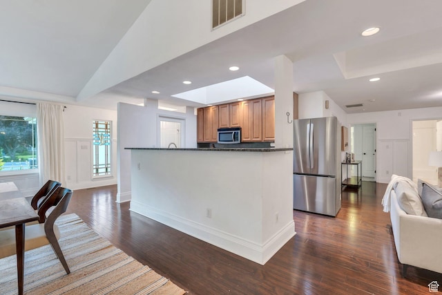 4055 N Cove Dr, Provo, UT 84604 - kitchen with appliances with stainless steel finishes, a skylight, dark wood-style flooring, open floor plan, and recessed lighting