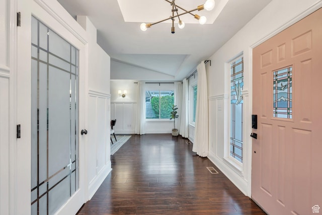 4055 N Cove Dr, Provo, UT 84604 - entrance foyer with a decorative wall, a chandelier, vaulted ceiling, dark wood-style floors, and a wainscoted wall