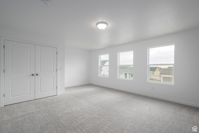1847 E Badger Ave N Unit B253, Eagle Mountain, UT 84005 - unfurnished bedroom featuring carpet floors, baseboards, and a closet