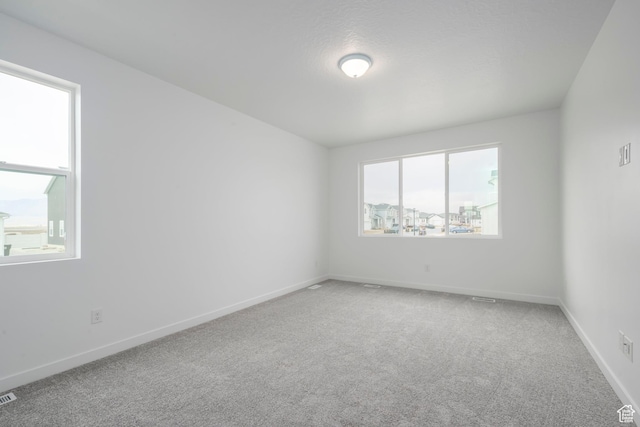 1847 E Badger Ave N Unit B253, Eagle Mountain, UT 84005 - unfurnished room featuring plenty of natural light, light colored carpet, and baseboards
