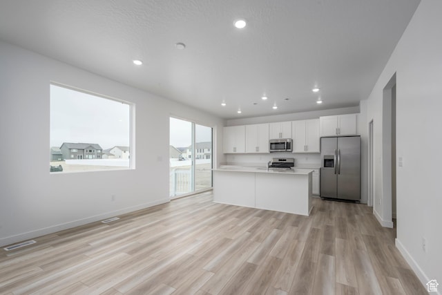 1847 E Badger Ave N Unit B253, Eagle Mountain, UT 84005 - kitchen with appliances with stainless steel finishes, light wood-style flooring, light countertops, white cabinetry, and recessed lighting