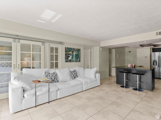 105 S 1100 E Unit 508, Salt Lake City, UT 84102 - living area featuring light tile patterned flooring, baseboards, and bar