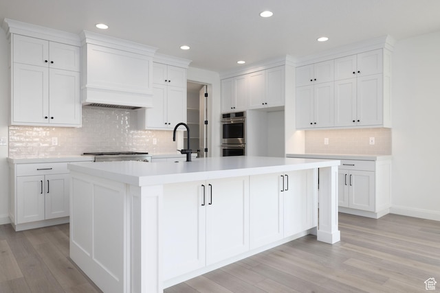 6527 W Barneys Creek Way, West Jordan, UT 84081 - kitchen featuring double oven, decorative backsplash, a sink, white cabinets, and recessed lighting