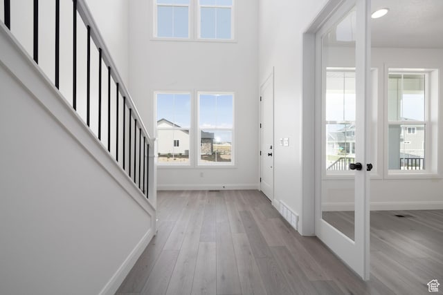 6527 W Barneys Creek Way, West Jordan, UT 84081 - entryway with plenty of natural light, baseboards, light wood finished floors, french doors, and a towering ceiling