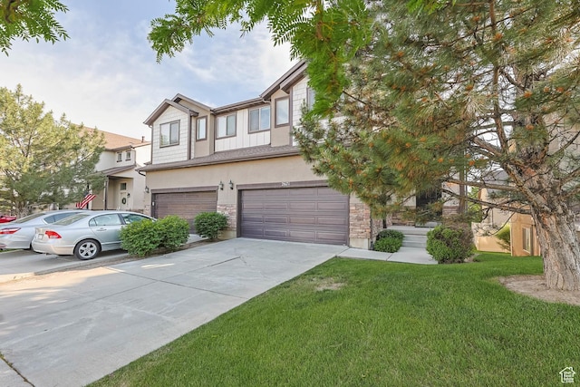 2671 N Garden Dr, Lehi, UT 84043 - townhome / multi-family property with an attached garage, stone siding, driveway, stucco siding, and a front lawn