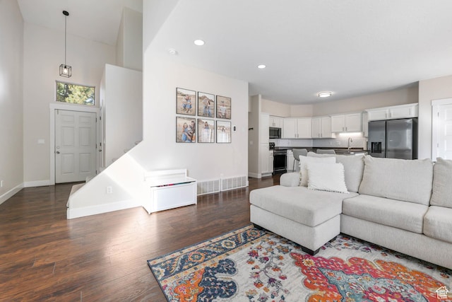2671 N Garden Dr, Lehi, UT 84043 - living area featuring baseboards, dark wood finished floors, recessed lighting, and a towering ceiling