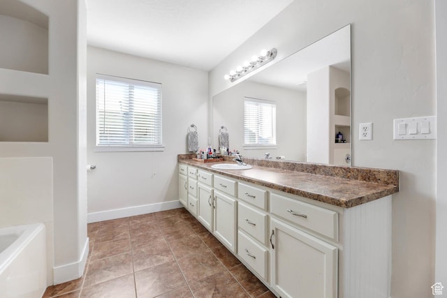 2671 N Garden Dr, Lehi, UT 84043 - bathroom featuring vanity, a bath, baseboards, and tile patterned flooring