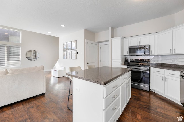 2671 N Garden Dr, Lehi, UT 84043 - kitchen with stainless steel appliances, open floor plan, dark wood-type flooring, tasteful backsplash, and a center island