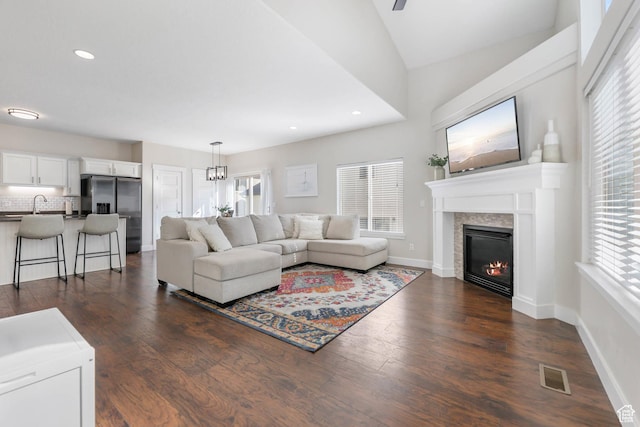 2671 N Garden Dr, Lehi, UT 84043 - living room featuring a glass covered fireplace, healthy amount of natural light, dark wood-style floors, and recessed lighting