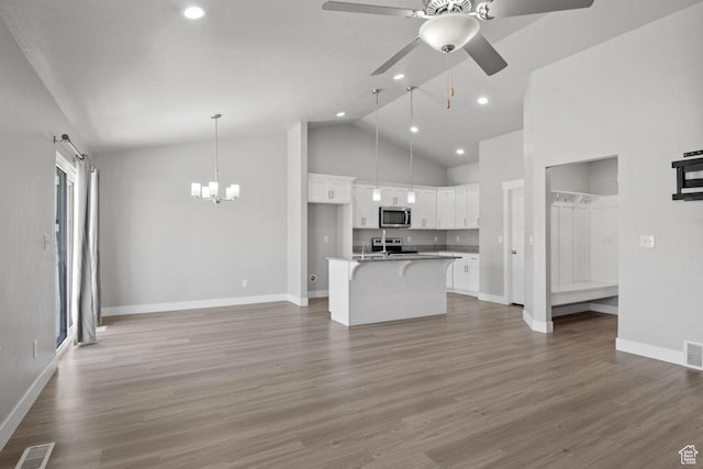 4972 N Sage Park Dr, Eagle Mountain, UT 84005 - unfurnished living room featuring ceiling fan, baseboards, recessed lighting, wood finished floors, and high vaulted ceiling