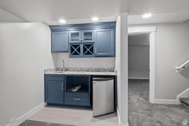 4972 N Sage Park Dr, Eagle Mountain, UT 84005 - indoor wet bar with baseboards, fridge, light colored carpet, stairs, and recessed lighting
