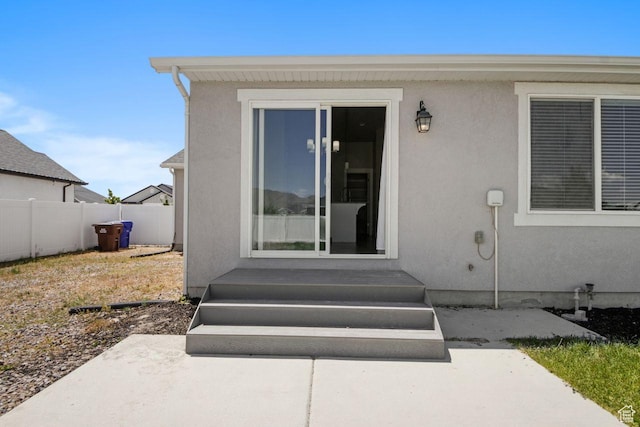 4972 N Sage Park Dr, Eagle Mountain, UT 84005 - entrance to property with stucco siding and a patio area