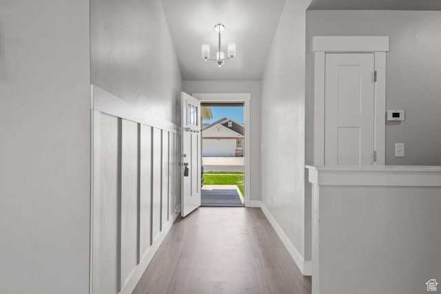 4972 N Sage Park Dr, Eagle Mountain, UT 84005 - doorway featuring a chandelier, wood finished floors, and baseboards