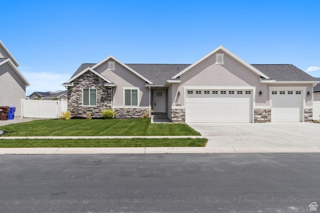 4972 N Sage Park Dr, Eagle Mountain, UT 84005 - view of front of property with stone siding, an attached garage, stucco siding, and concrete driveway