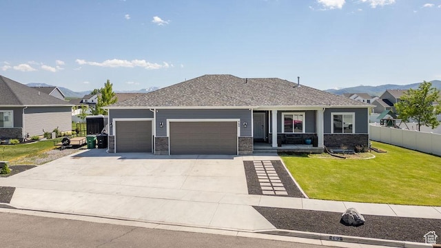 460 E 535 S, Hyrum, UT 84319 - view of front facade with an attached garage, concrete driveway, a porch, and roof with shingles