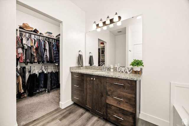 460 E 535 S, Hyrum, UT 84319 - full bathroom with vanity, wood finished floors, a walk in closet, and baseboards