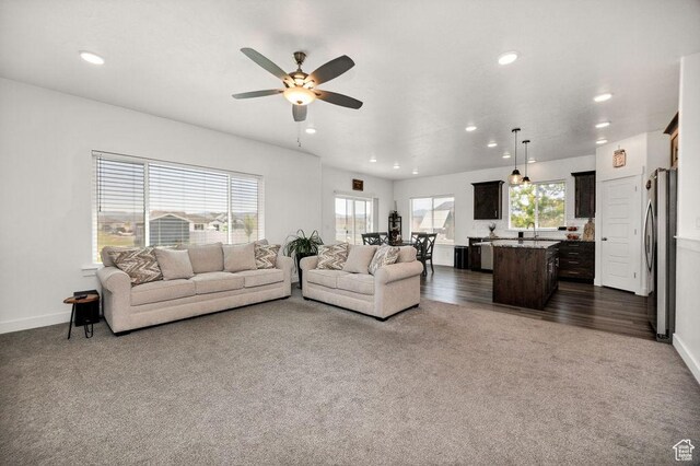460 E 535 S, Hyrum, UT 84319 - living room featuring dark carpet, recessed lighting, a ceiling fan, healthy amount of natural light, and baseboards