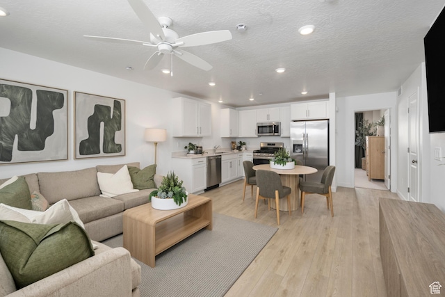 224 N Loring Ave Unit 112, Santaquin, UT 84655 - living area featuring a ceiling fan, recessed lighting, light wood-type flooring, and a textured ceiling