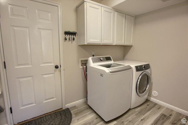 7939 S 2450 E, South Weber, UT 84405 - washroom featuring cabinet space, independent washer and dryer, light wood-type flooring, and baseboards
