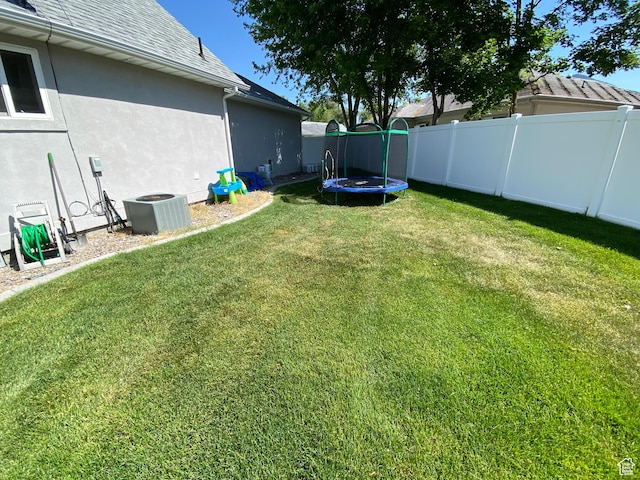 85 River Pointe Dr, Logan, UT 84321 - view of yard featuring a trampoline and central AC