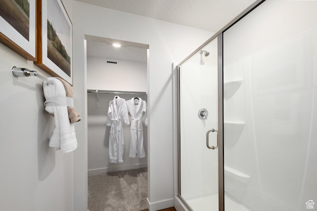 2506 N Wildwood Ln E Unit 243, Heber City, UT 84032 - full bathroom featuring a shower stall and a walk in closet