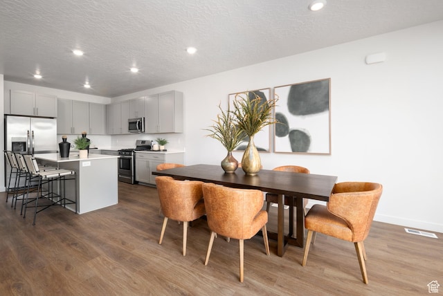 2506 N Wildwood Ln E Unit 243, Heber City, UT 84032 - dining room with dark wood finished floors, recessed lighting, a textured ceiling, and baseboards