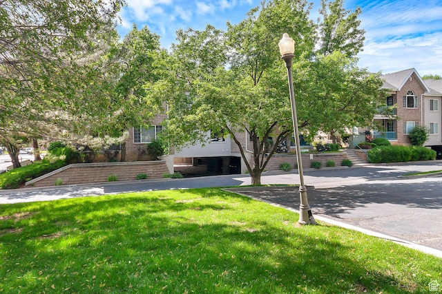 4910 N University Ave Unit 52, Provo, UT 84604 - view of property hidden behind natural elements with a front yard and brick siding
