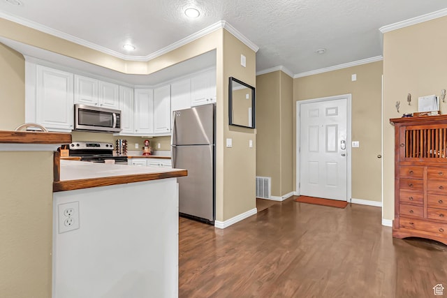 4910 N University Ave Unit 52, Provo, UT 84604 - kitchen with appliances with stainless steel finishes, dark wood-type flooring, white cabinets, ornamental molding, and baseboards