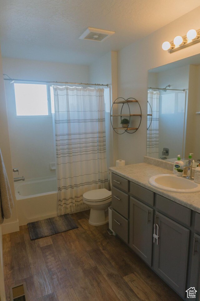 12959 S Penywain Ln W, Herriman, UT 84096 - bathroom with wood finished floors, vanity, toilet, and shower / tub combo