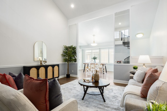 1155 E Murray Holladay Rd, Millcreek, UT 84117 - living area with high vaulted ceiling, wood finished floors, recessed lighting, baseboards, and stairs