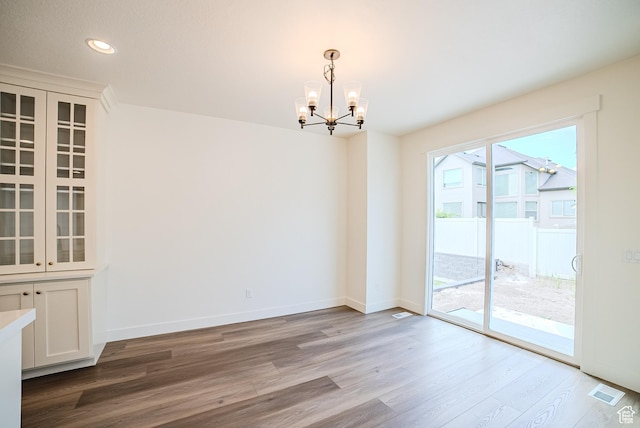 10926 S Little Sahara Dr Unit 1002, South Jordan, UT 84009 - unfurnished dining area with a chandelier, wood finished floors, recessed lighting, and baseboards