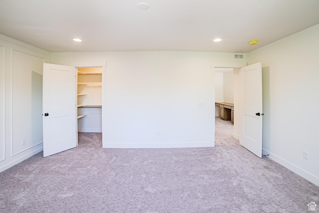 10926 S Little Sahara Dr Unit 1002, South Jordan, UT 84009 - unfurnished bedroom with light colored carpet, recessed lighting, a spacious closet, and baseboards