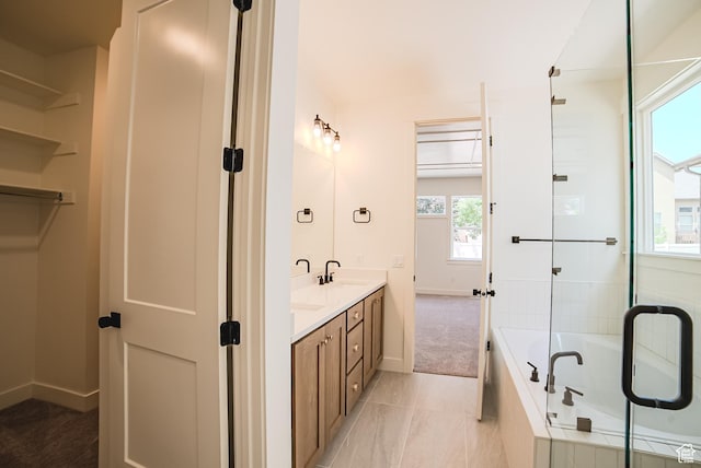 10926 S Little Sahara Dr Unit 1002, South Jordan, UT 84009 - bathroom featuring double vanity, a bath, and baseboards