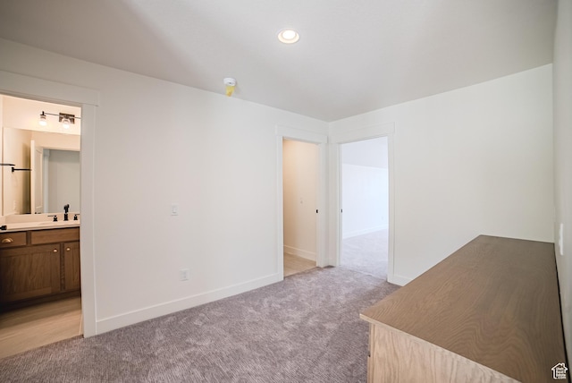 10926 S Little Sahara Dr Unit 1002, South Jordan, UT 84009 - unfurnished bedroom with light carpet, a sink, baseboards, and connected bathroom