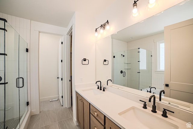 10926 S Little Sahara Dr Unit 1002, South Jordan, UT 84009 - full bathroom with double vanity, a stall shower, and baseboards