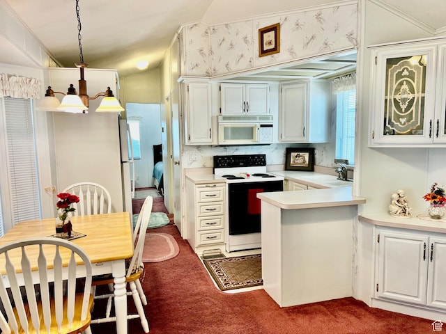 1160 E Telegraph St Unit 49, Washington, UT 84780 - kitchen with white appliances, dark carpet, light countertops, a sink, and a peninsula