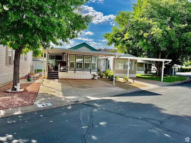 1160 E Telegraph St Unit 49, Washington, UT 84780 - manufactured / mobile home with covered porch and a carport