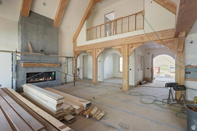 2556 W 5600 S, Lake Shore, UT 84660 - unfurnished living room with high vaulted ceiling, a large fireplace, and beamed ceiling