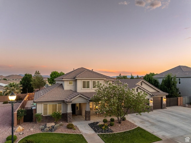 2914 E 1880 S, St George, UT 84790 - view of front of home featuring a tiled roof, driveway, stucco siding, and a garage