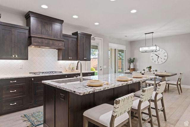 2914 E 1880 S, St George, UT 84790 - kitchen featuring stainless steel gas stovetop, a sink, backsplash, light wood-style flooring, and recessed lighting