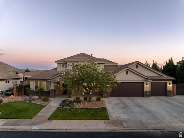 2914 E 1880 S, St George, UT 84790 - view of front facade featuring an attached garage, concrete driveway, stucco siding, and stone siding